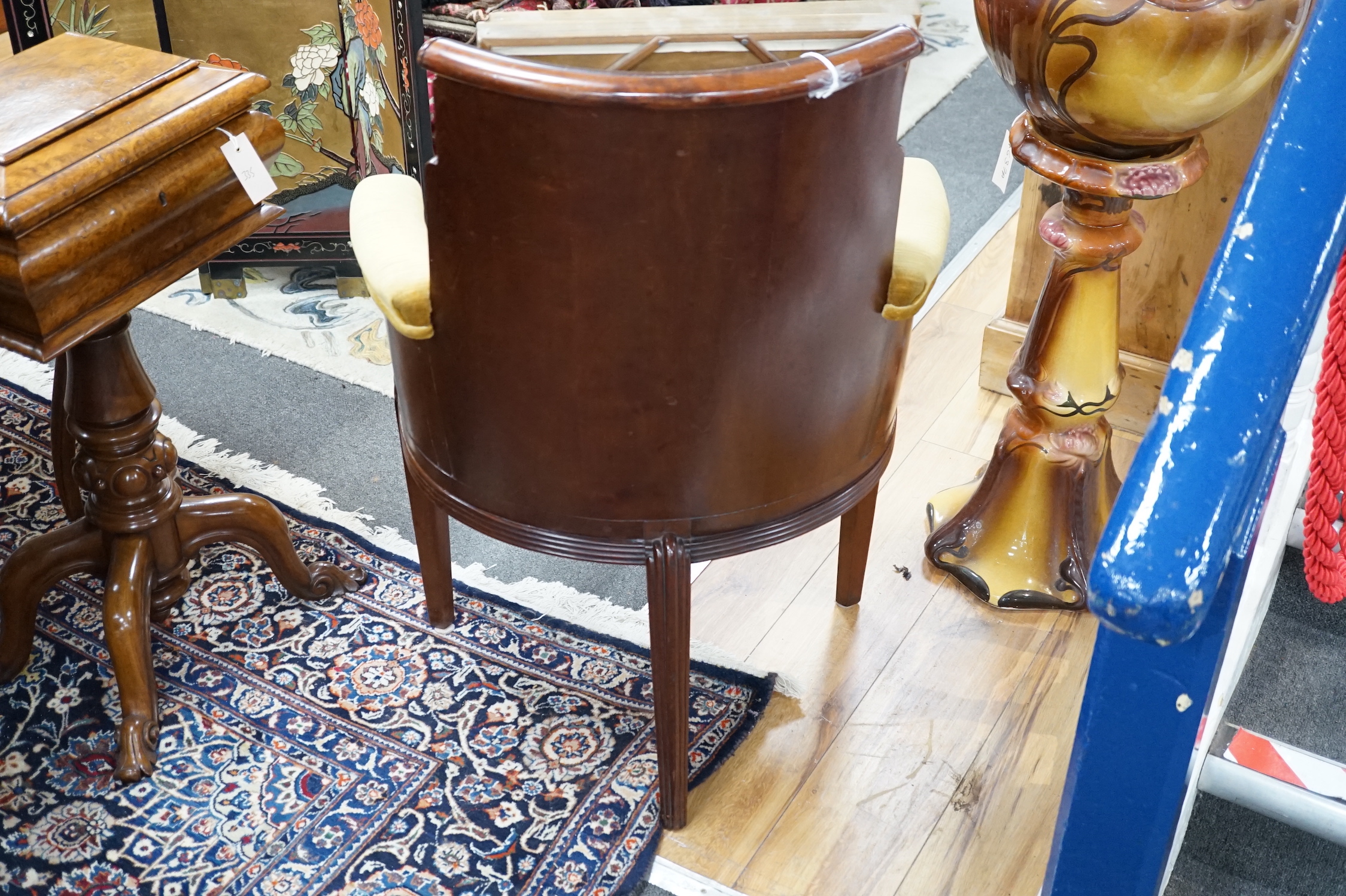 A stylish Art Deco mahogany elbow chair by Trollope and Son, numbered 4088, height 95cm *Please note the sale commences at 9am.
